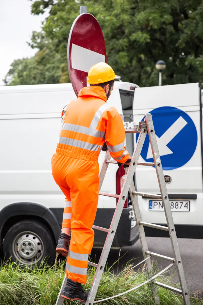 Image of Man climbing a ladder wearing safety boots